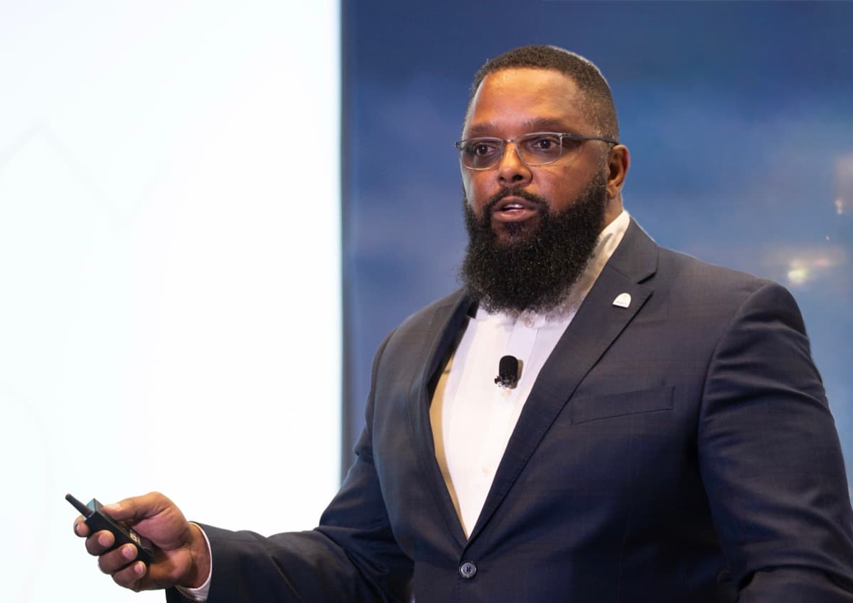 William Simmons speaking on stage about AI and operations